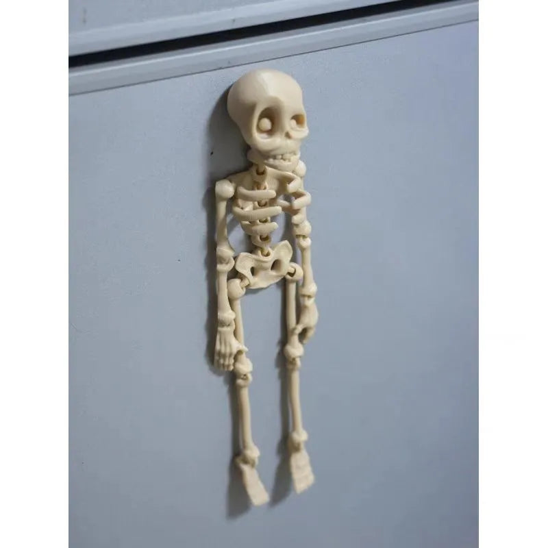 3D printed white skull Halloween fridge magnet on a metal surface showing detailed design.