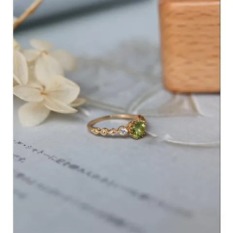 Copper ring with a green quadrilateral imitation peridot stone in a geometric Japanese retro style.