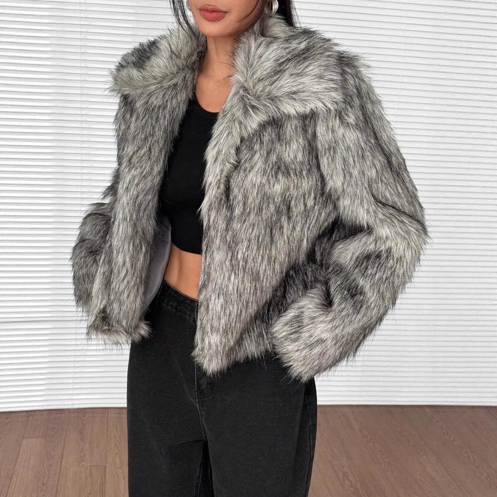 Women's short black and white artificial fur coat with a large fur collar, shown in a cute style pose.