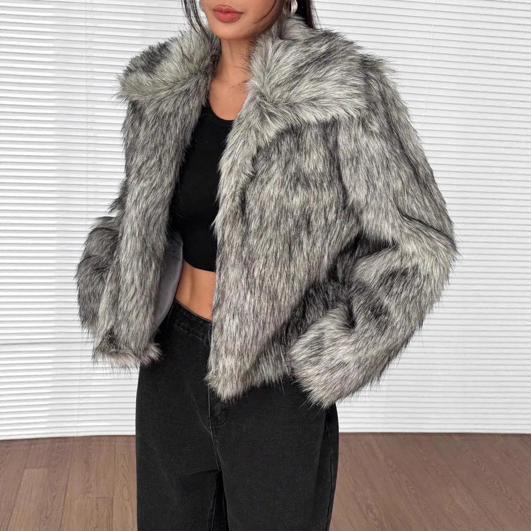 Women's short black and white artificial fur coat with a large fur collar, shown in a cute style pose.