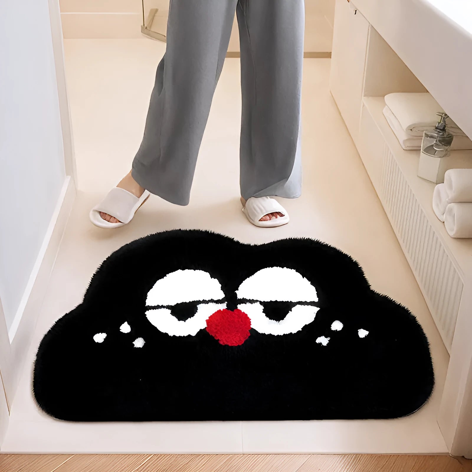 Big eye clouds cartoon patterned bathroom mat in soft green on a bathroom floor.