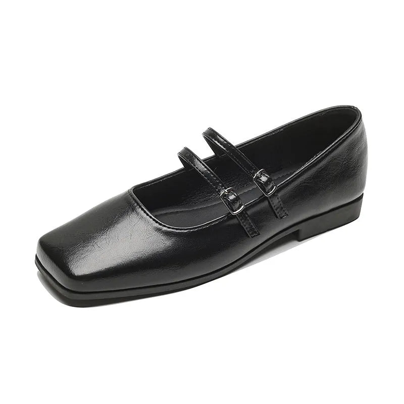 Silver women's leather Mary Jane flats with a cross buckle strap and round toe
