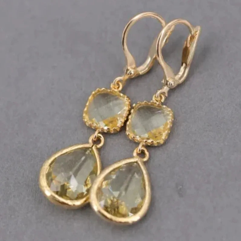 Gold geometric earrings with long crystal fringe and water droplet design on copper base