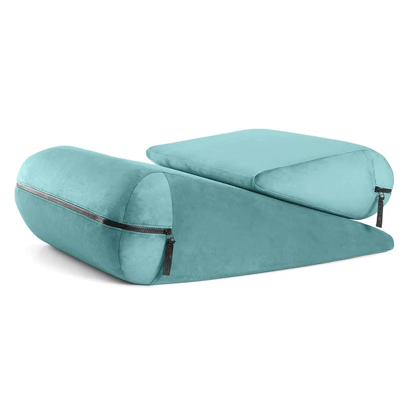A grey embroidered triangle cushion pad on a sofa corner, showing its geometric wedge shape and textured surface.