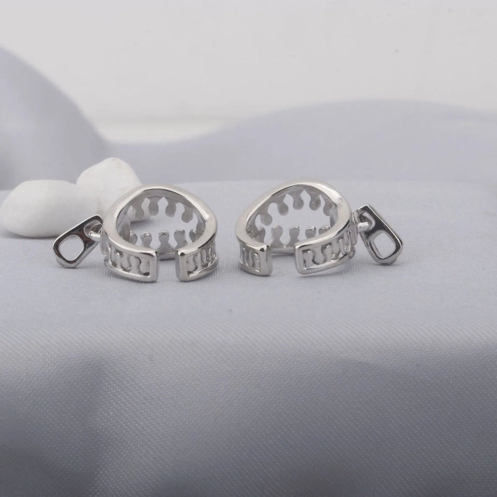 Copper geometric ear clip with line details and a zipper-style clip in colour ES862