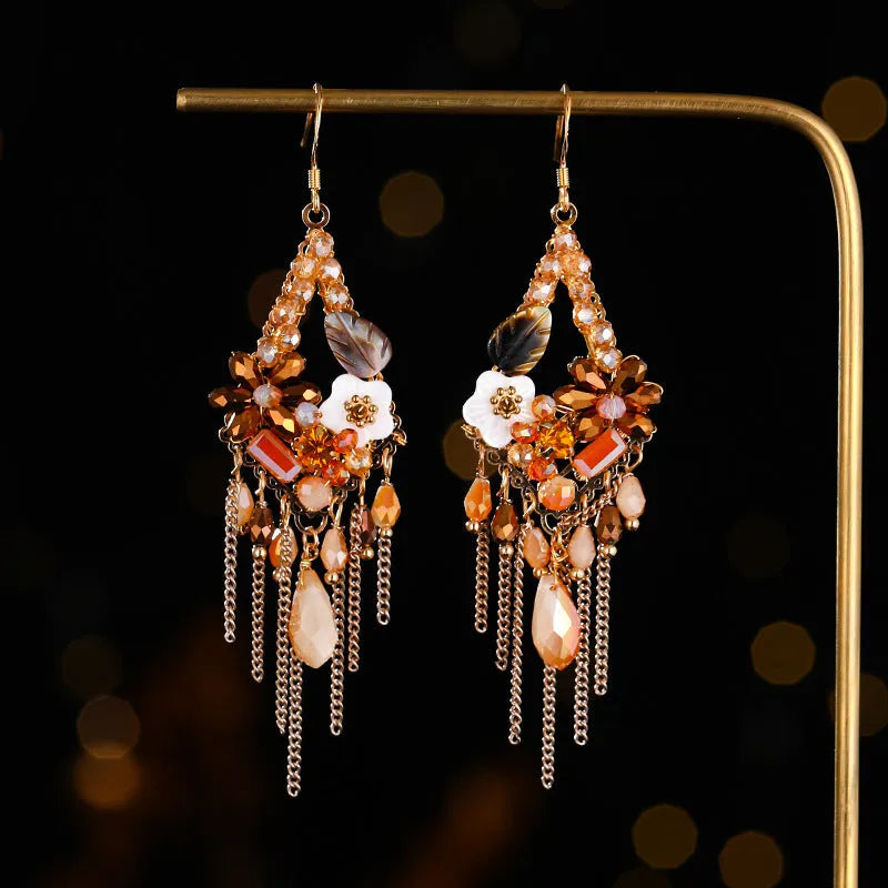Long bohemian-style women's earrings with hand-woven artificial crystal in a diamond shape.