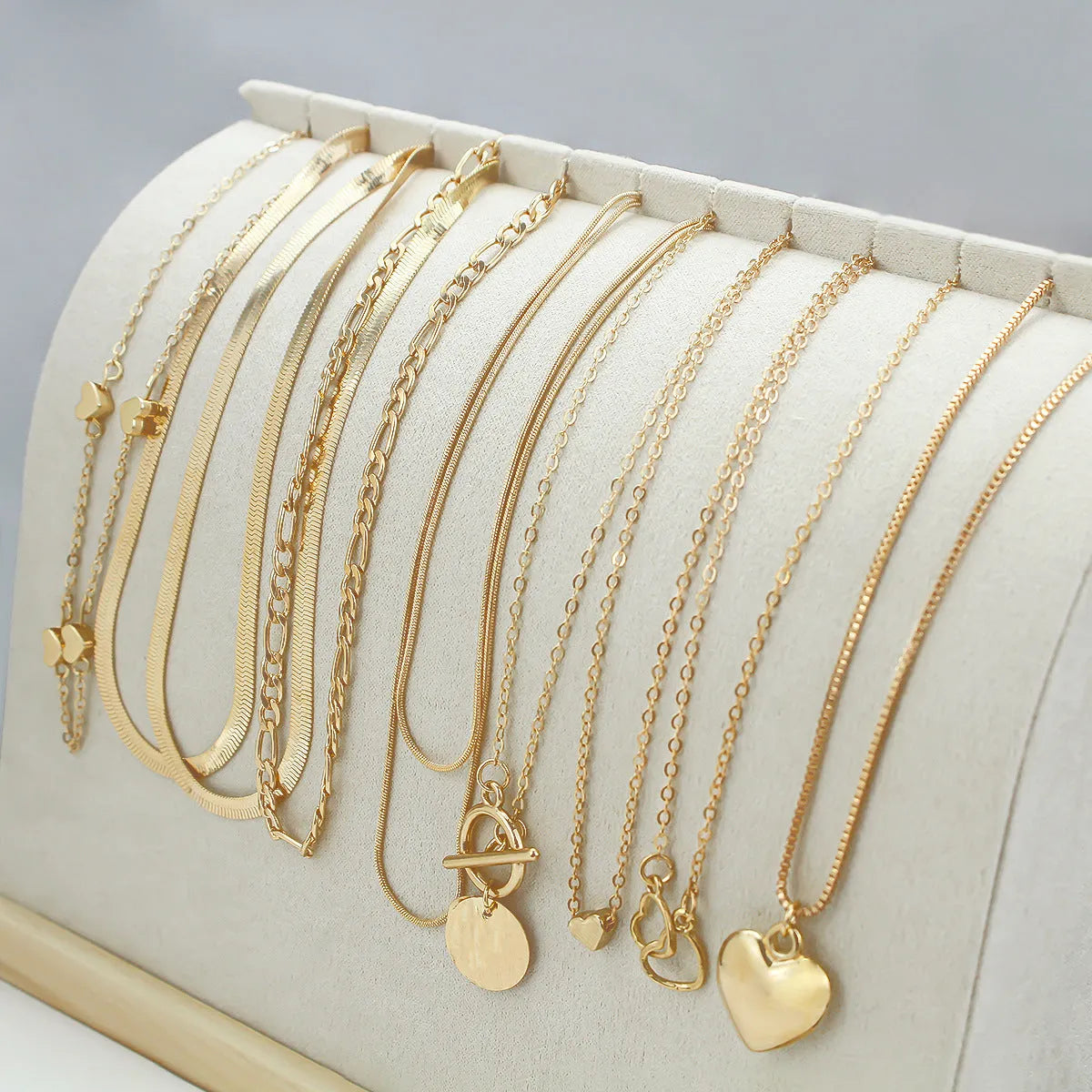 Gold women's 10-piece necklace set with alloy pendant on an adjustable snake bones chain.