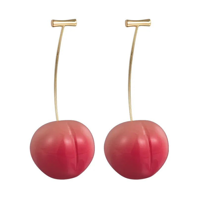 A pair of acrylic earrings shaped like juicy peaches in soft colour tones on copper earring findings.