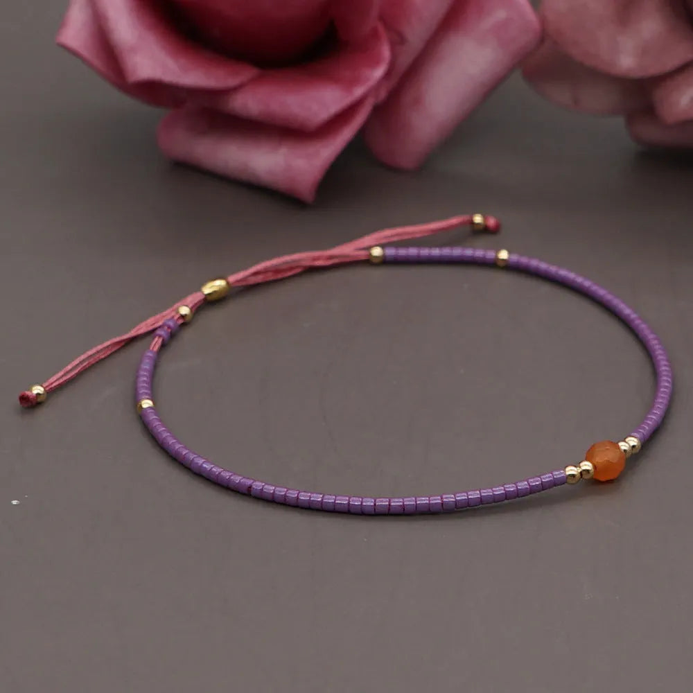 Handmade bohemian style bracelet with geometric glass and coloured glaze beads in various colours
