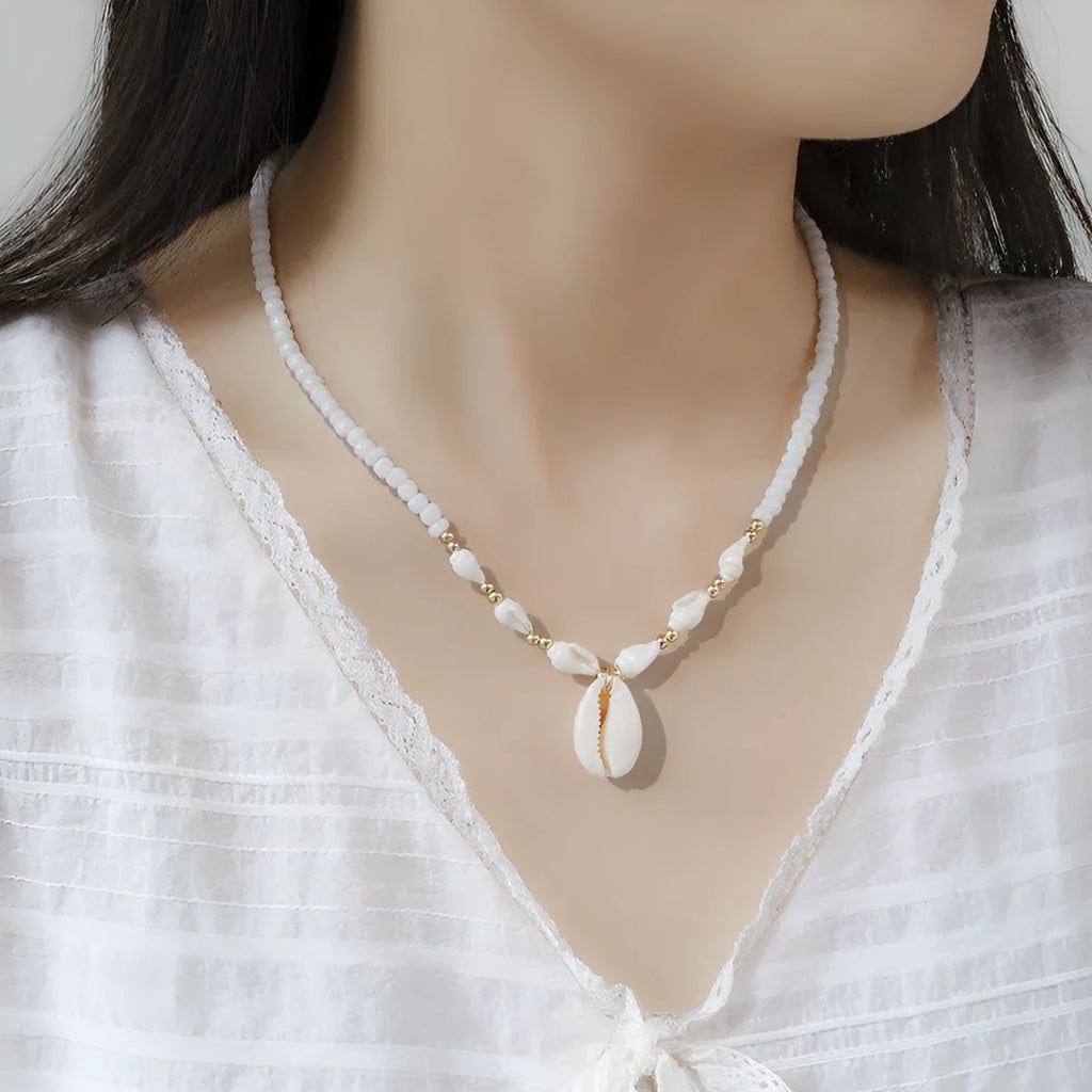 White electroplated shell necklace with conch bead mother-of-pearl pendant on a regular chain.