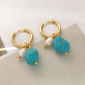 Geometric turquoise and cultured pearl drop earrings and short earrings set on copper base.