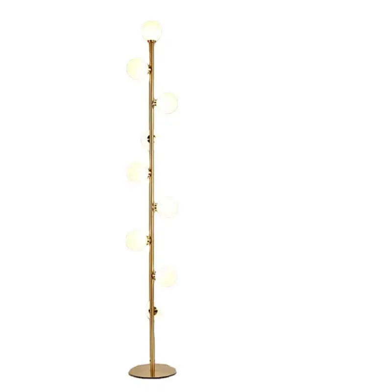 Modern black floor lamp with a glass shade on a wrought iron stand and circular marble base.