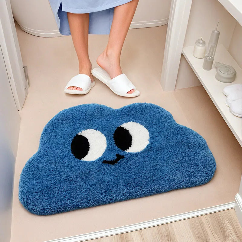 Big eye clouds cartoon patterned bathroom mat in soft green on a bathroom floor.