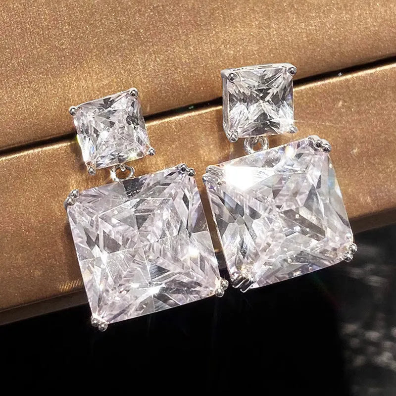 A pair of geometric square copper earrings for women in a choice of gold or white gold tone.