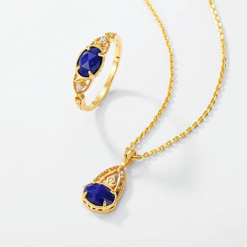 A geometric silver-tone alloy ring in a lapis lazuli colour, showing its elliptical profile and rounded elements.