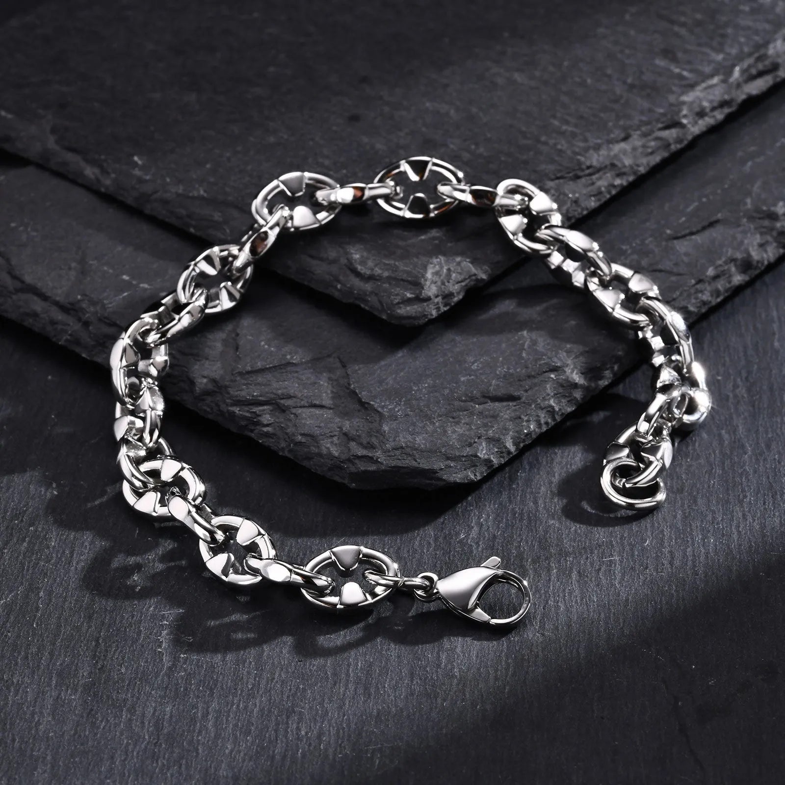 Thick stainless steel handmade chain bracelet with a geometric shape in a steel colour.