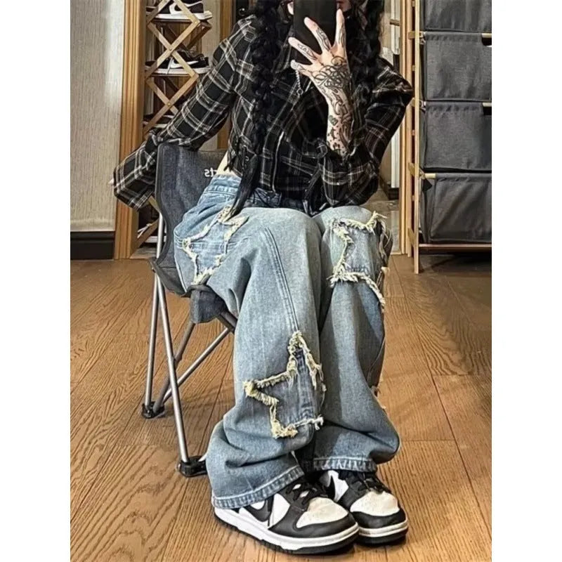 Blue high waist straight leg jeans for women laid flat, showing the denim texture and classic cut.