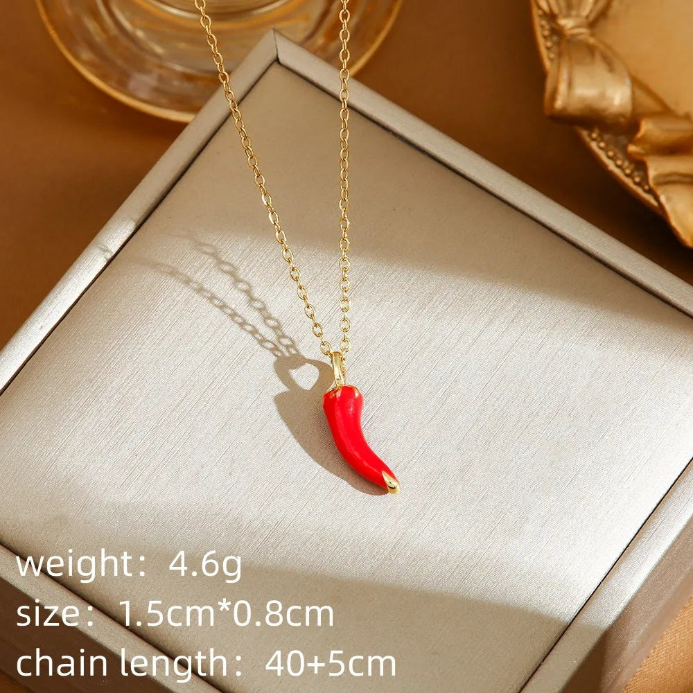 Red delicate indie necklace with cherry, strawberry, and pepper charms on a titanium steel O-ring chain.