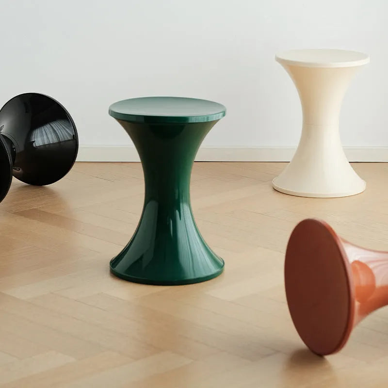 A plastic hourglass-style shoe changing stool, shown in one of the available colours.