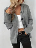 A thick grey cotton hooded cardigan sweater with a single-breasted front and long sleeves, shown on a model.