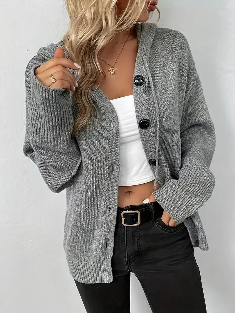 A thick grey cotton hooded cardigan sweater with a single-breasted front and long sleeves, shown on a model.