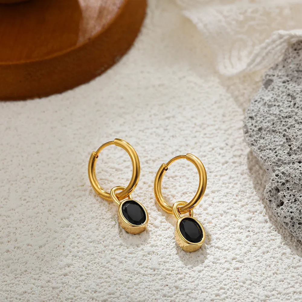 Close-up of women's simple oval zircon stud earrings in copper, showing army green and emerald colour options on a white background.
