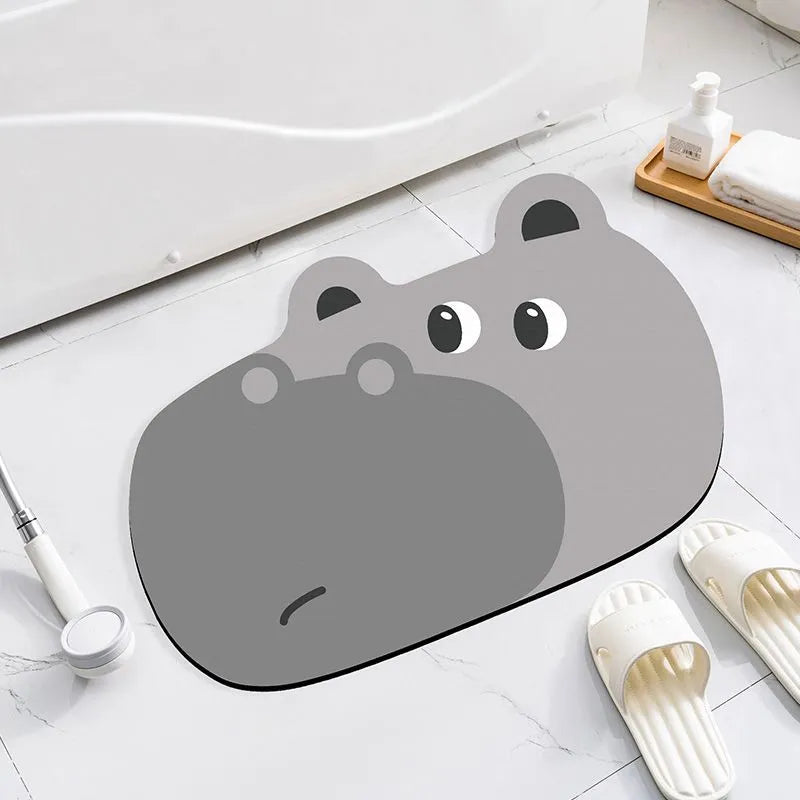 Cartoon animal diatom absorbent bathroom mat in bear pattern on tiled floor.