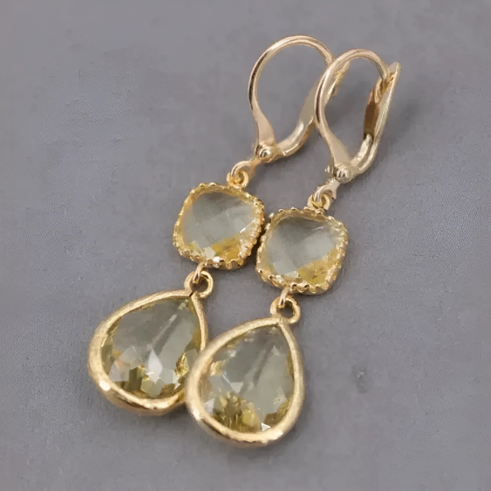 Gold geometric earrings with long crystal fringe and water droplet design on copper base