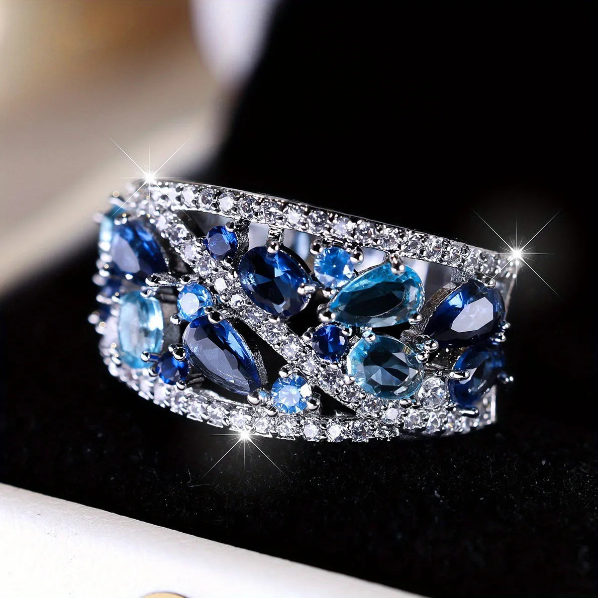 Women's round hollow copper fashion ring with a choice of diamond or sapphire blue gemstone accent.