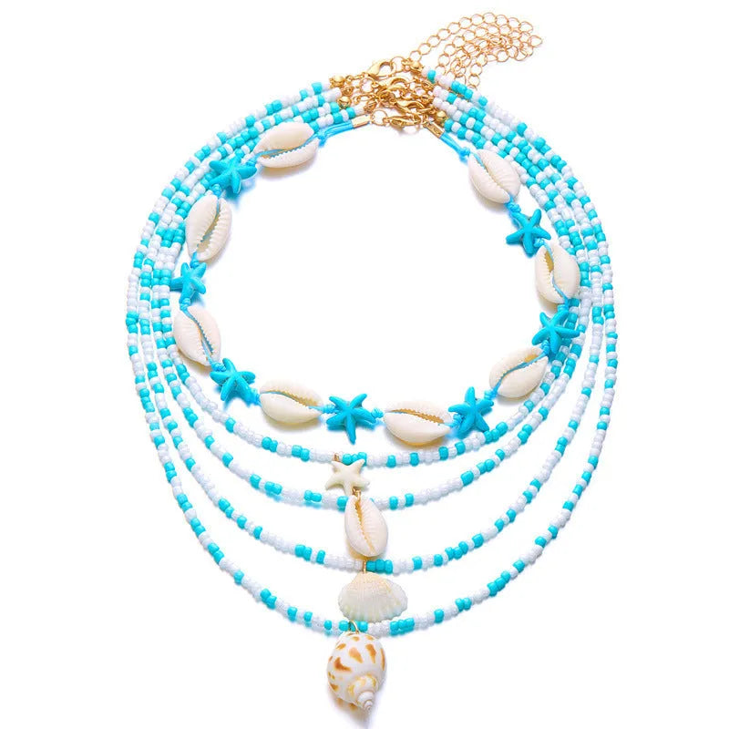 Blue electroplated women's necklace set with starfish and conch shell beads on adjustable chain