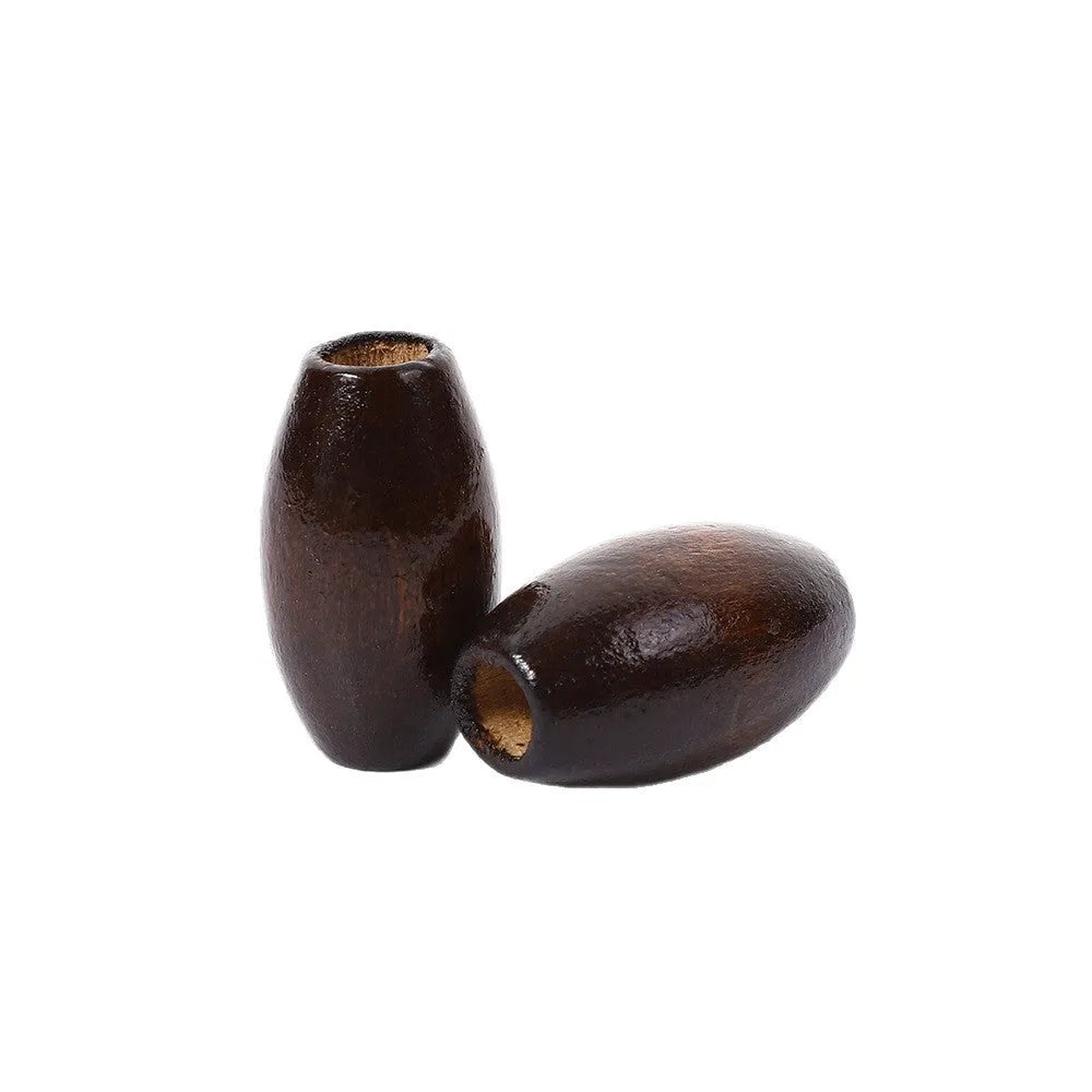 Dark brown oval wooden bead with raised M-shaped profile on a white background.