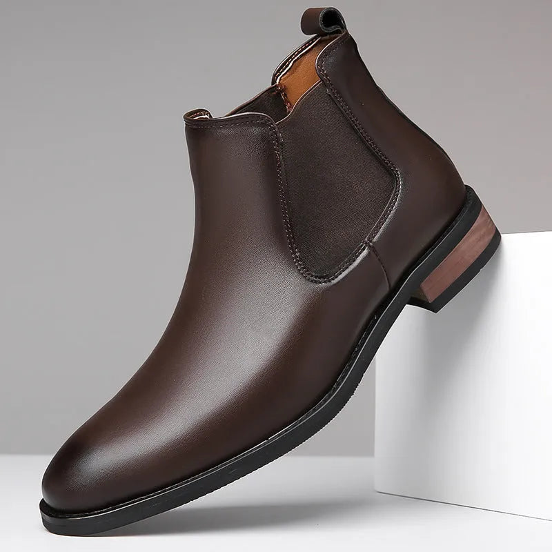 Men's black Chelsea boots with pointed toe design, sewing thread details and rubber sole