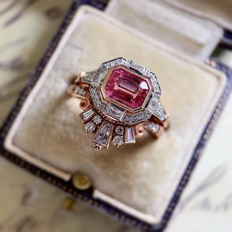 Rose gold coloured alloy women's ring with a geometric retro ruby style design on a hand.