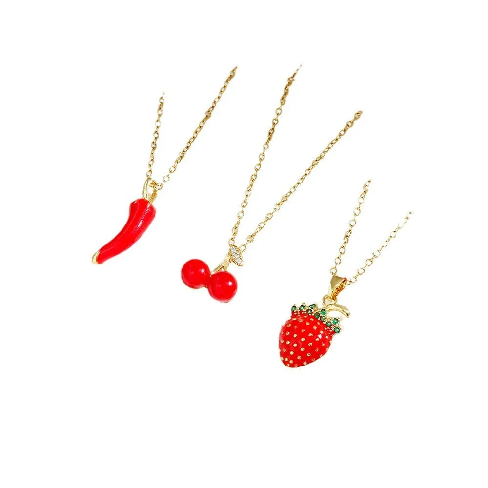 Red delicate indie necklace with cherry, strawberry, and pepper charms on a titanium steel O-ring chain.