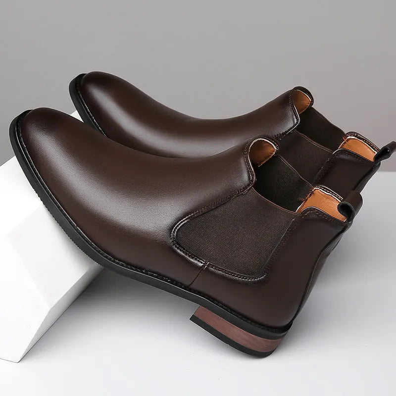 Men's black Chelsea boots with pointed toe design, sewing thread details and rubber sole
