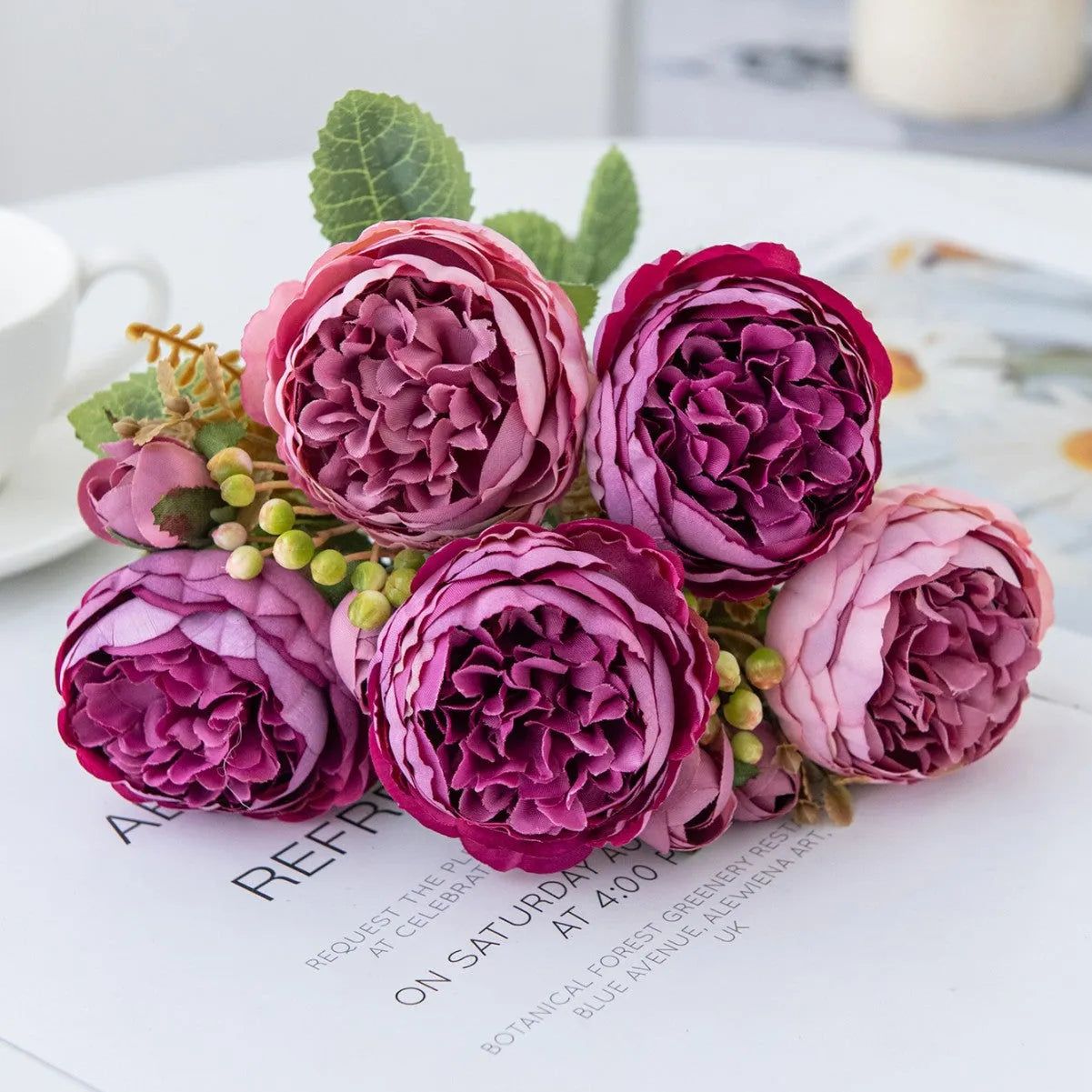 Artificial silk peony bouquet in a vase, showing realistic pink and champagne coloured blooms for home decor.