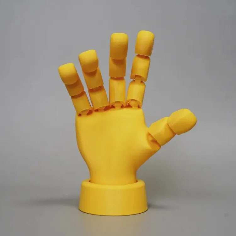 Yellow movable joint hand ornament figurine made of PLA plastic on a plain background