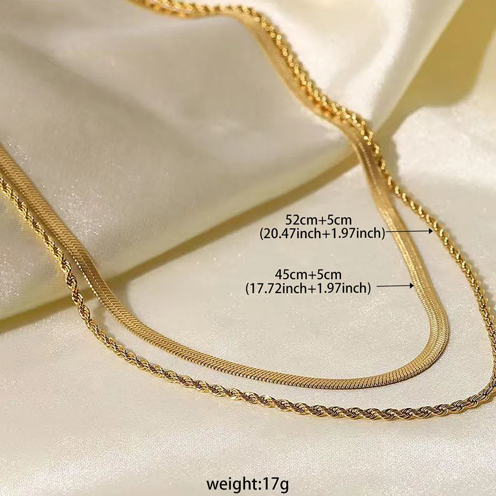 Close-up of a women's silver geometric twist necklace on an adjustable snake chain, showing its layered stainless steel pendant.
