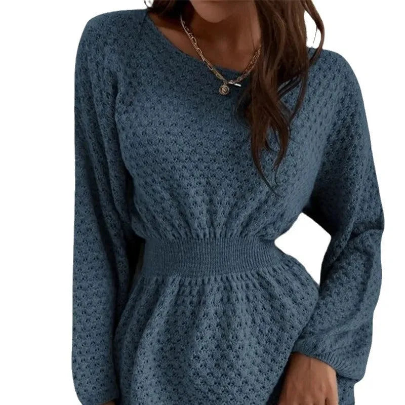 Blue knitted dress with fitted waist, round neck, long sleeves, and white crocheted flower details.