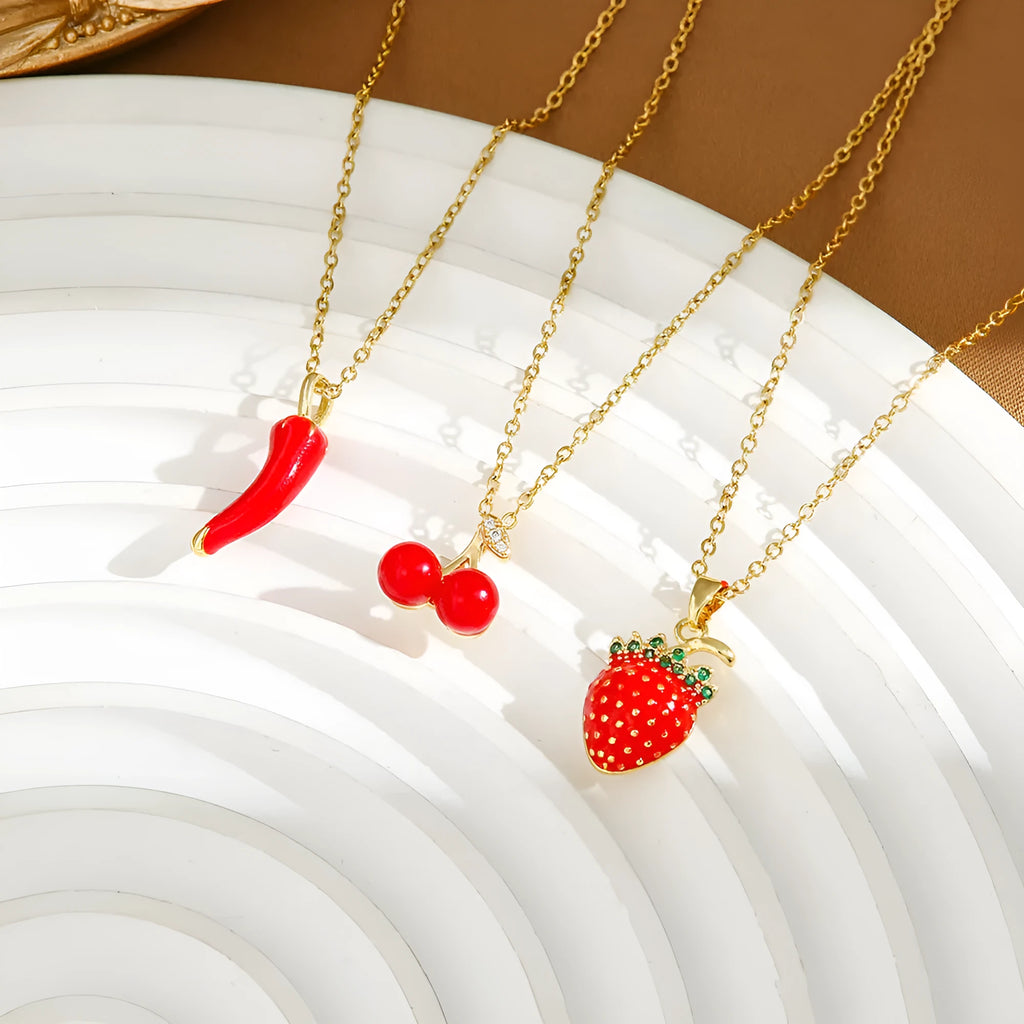 Red delicate indie necklace with cherry, strawberry, and pepper charms on a titanium steel O-ring chain.