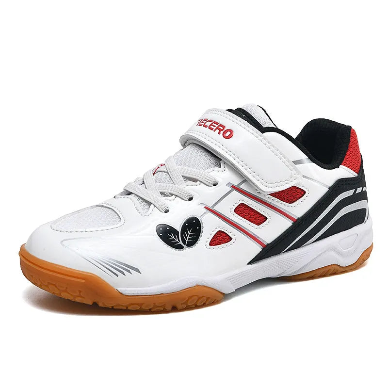 Low-top white and blue badminton shoes with a ribbed sole on a hard court surface.
