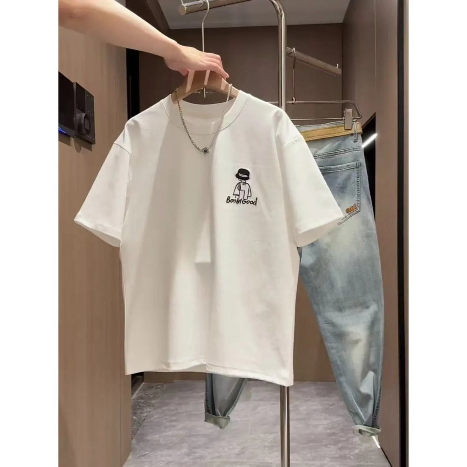 Men's white cotton T-shirt with simple cartoon print showing loose fit and short sleeves