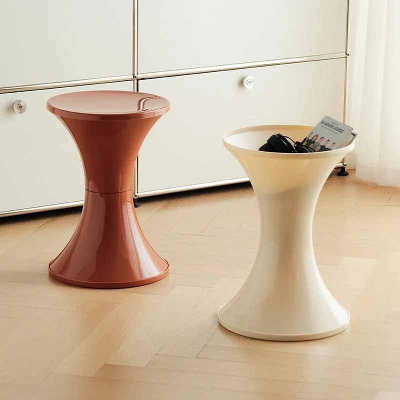 A plastic hourglass-style shoe changing stool, shown in one of the available colours.