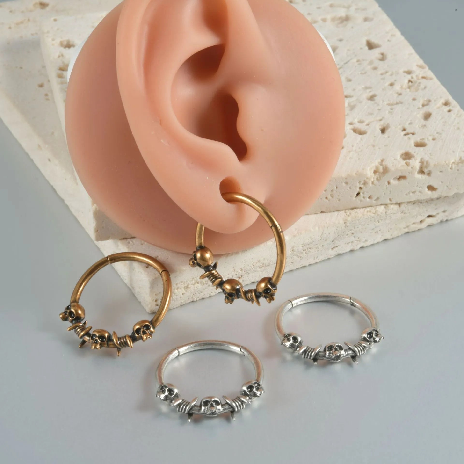 Copper antique finish punk earring with ghost head design in silver or gold.