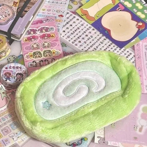 A plush velvet pencil case designed like a Swiss roll cake, in a Korean style.