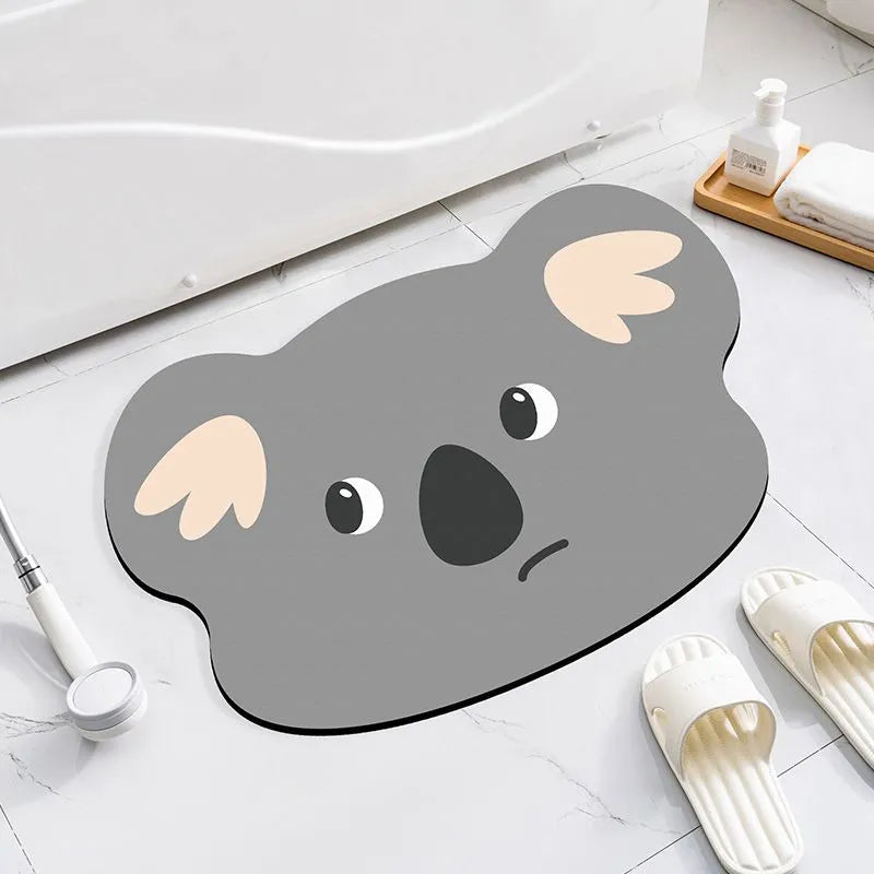 Cartoon animal diatom absorbent bathroom mat in bear pattern on tiled floor.
