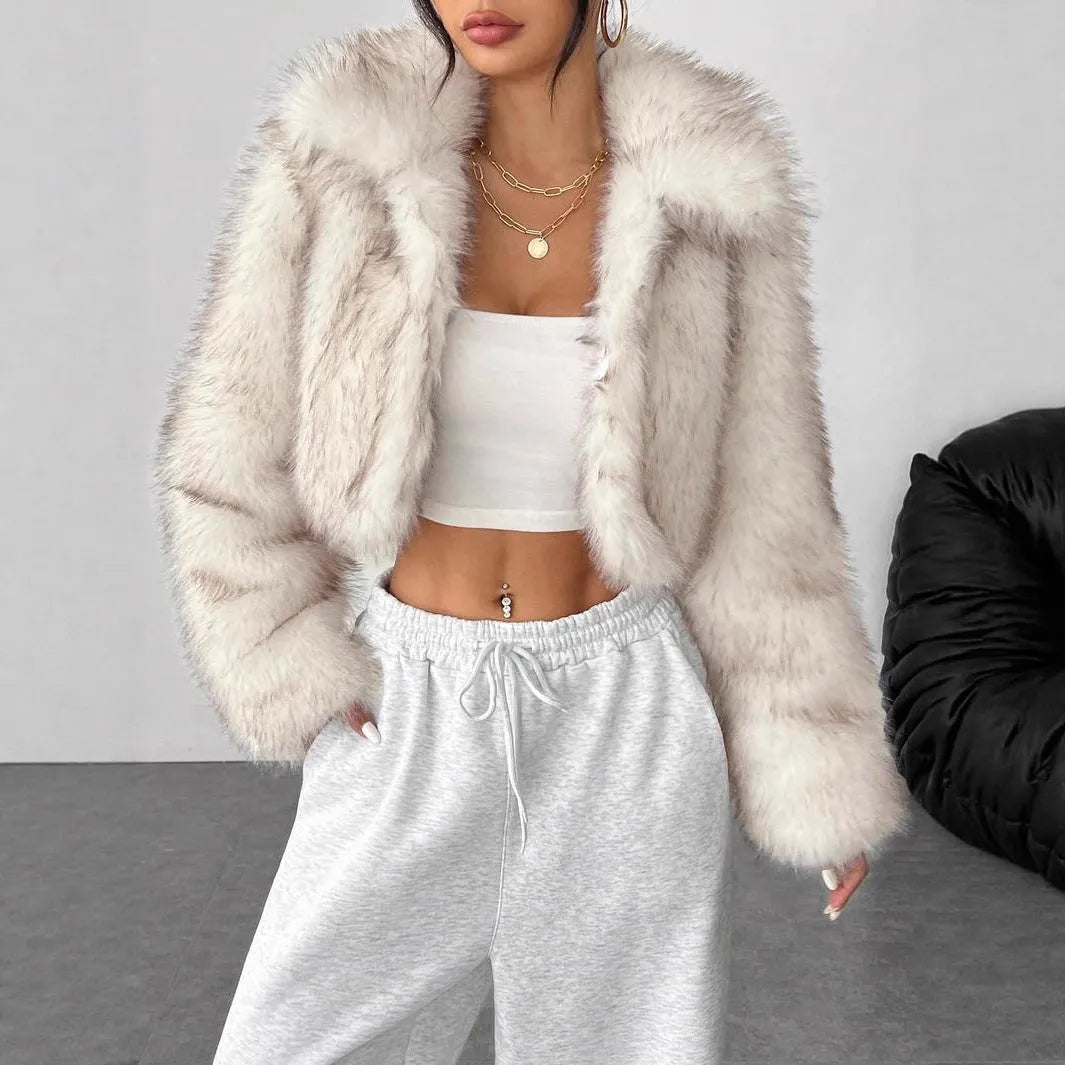Women's short black and white artificial fur coat with a large fur collar, shown in a cute style pose.