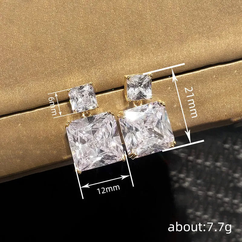 A pair of geometric square copper earrings for women in a choice of gold or white gold tone.