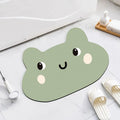Cartoon animal diatom absorbent bathroom mat in bear pattern on tiled floor.