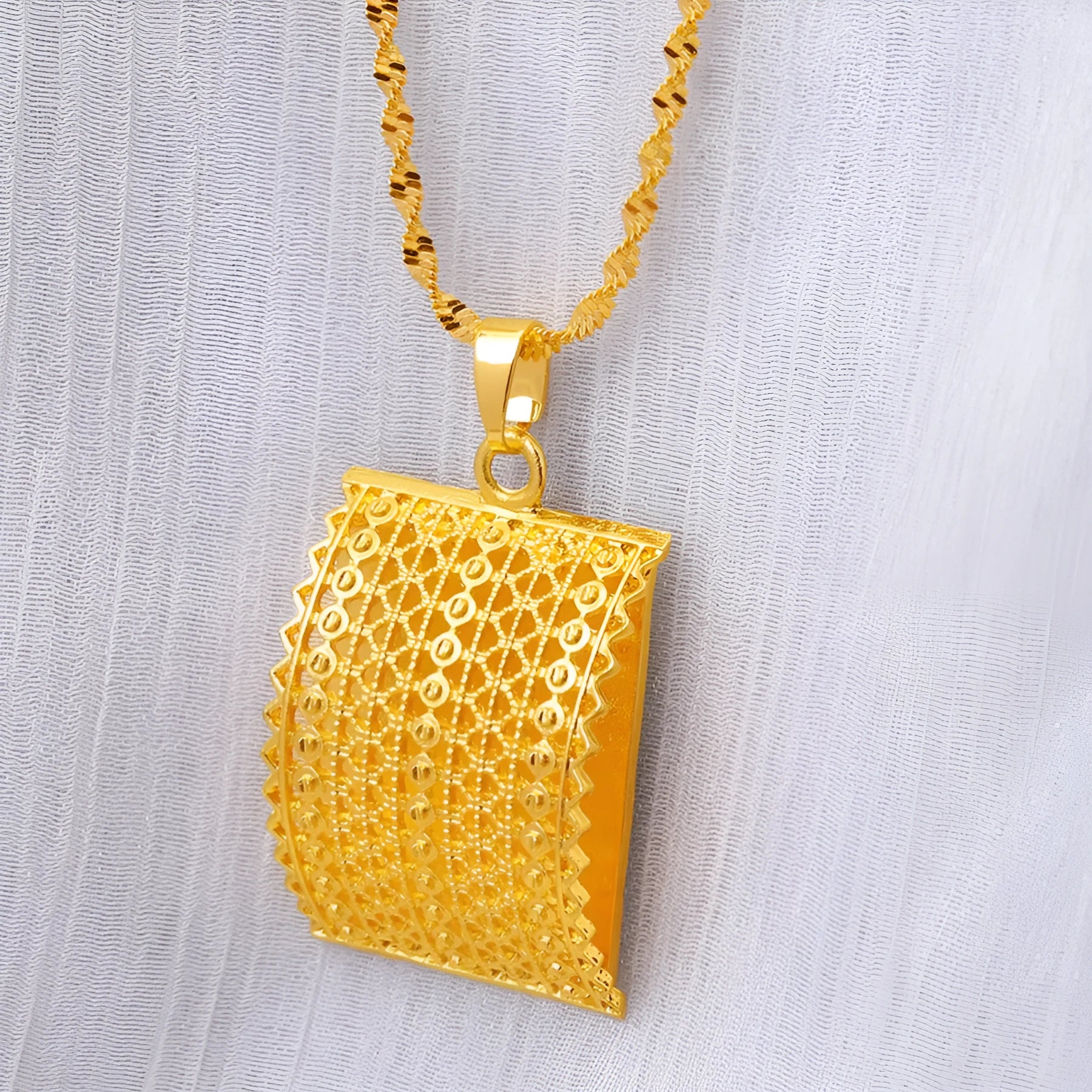 Gold-coloured bridal jewellery set with necklace, earrings, and ring on copper base